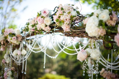 rustic willow wedding ceremony arch with roses and beads