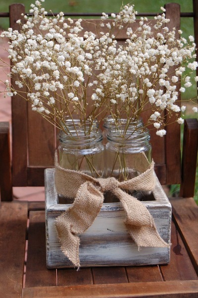 Wedding flowers in rustic glass jars